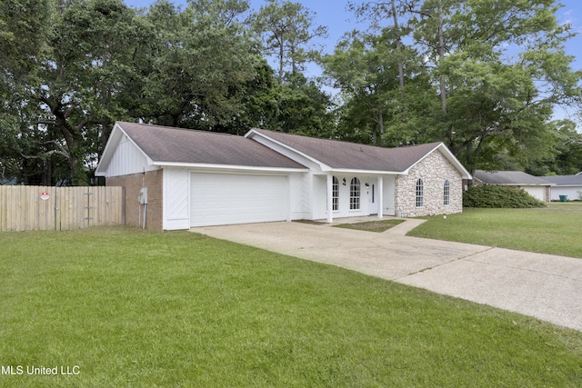 single story home with a garage, fence, stone siding, a front yard, and driveway
