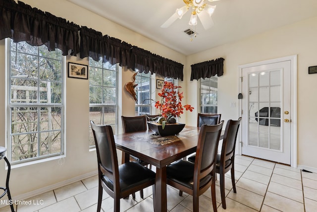 dining space with light tile patterned flooring and ceiling fan