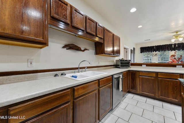 kitchen featuring ceiling fan, dishwasher, sink, and light tile patterned floors