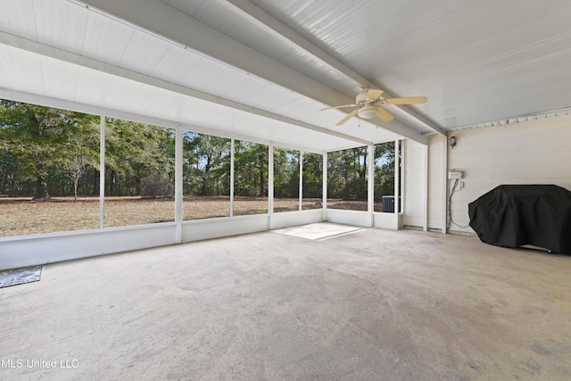 unfurnished sunroom with ceiling fan