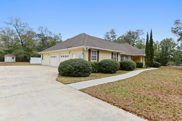 ranch-style home with a garage and a front yard