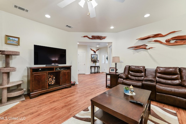 living room featuring ceiling fan and light wood-type flooring