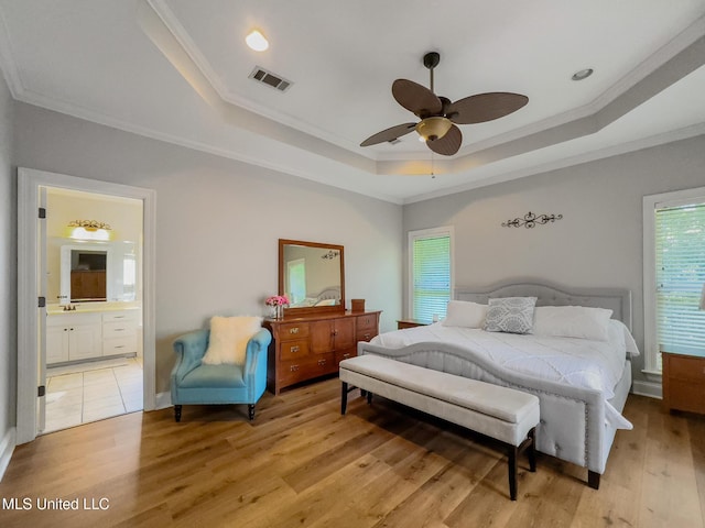 66 Auburn Pl, Hattiesburg, MS 39402 - bedroom featuring a raised ceiling, ornamental molding, light wood-style floors, ensuite bath, and a ceiling fan