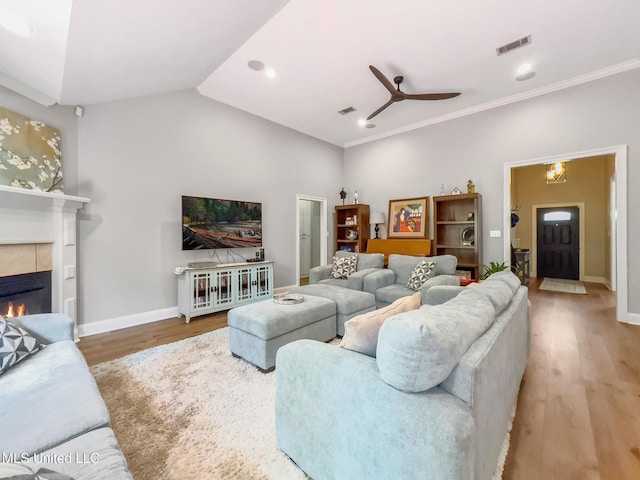 66 Auburn Pl, Hattiesburg, MS 39402 - living area featuring a tile fireplace, wood finished floors, a ceiling fan, baseboards, and vaulted ceiling