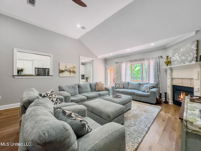 66 Auburn Pl, Hattiesburg, MS 39402 - living area featuring baseboards, a fireplace, vaulted ceiling, a ceiling fan, and light wood-style flooring