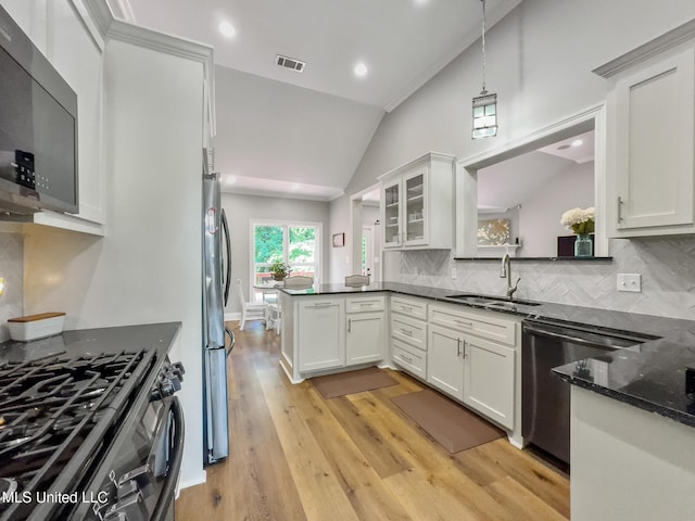 66 Auburn Pl, Hattiesburg, MS 39402 - kitchen with a sink, black appliances, lofted ceiling, light wood-type flooring, and decorative backsplash