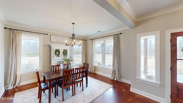 dining area featuring crown molding and a notable chandelier