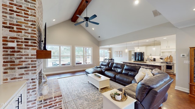 living room with high vaulted ceiling, a wealth of natural light, beam ceiling, and ceiling fan