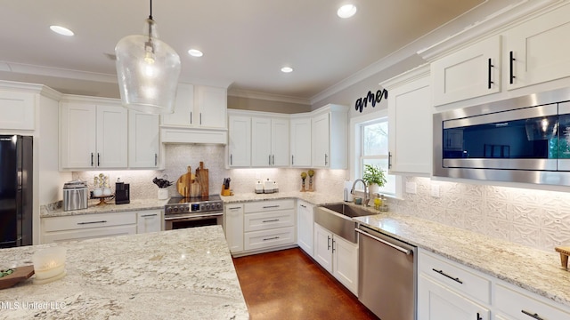 kitchen featuring decorative light fixtures, appliances with stainless steel finishes, sink, and white cabinetry