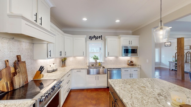 kitchen featuring pendant lighting, white cabinets, stainless steel appliances, sink, and backsplash