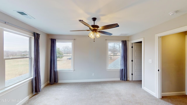 empty room featuring light carpet and ceiling fan