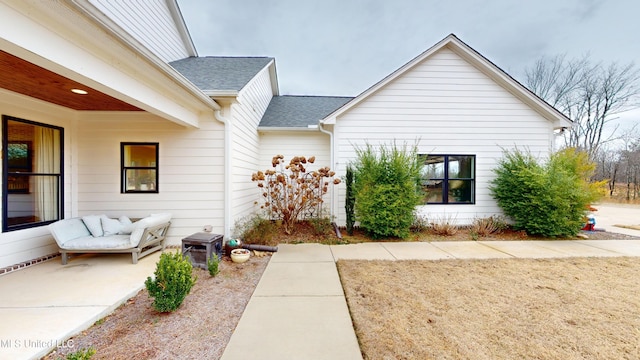 view of side of property featuring a patio area and outdoor lounge area