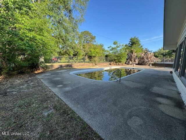 view of yard with a patio area, a fenced in pool, and fence