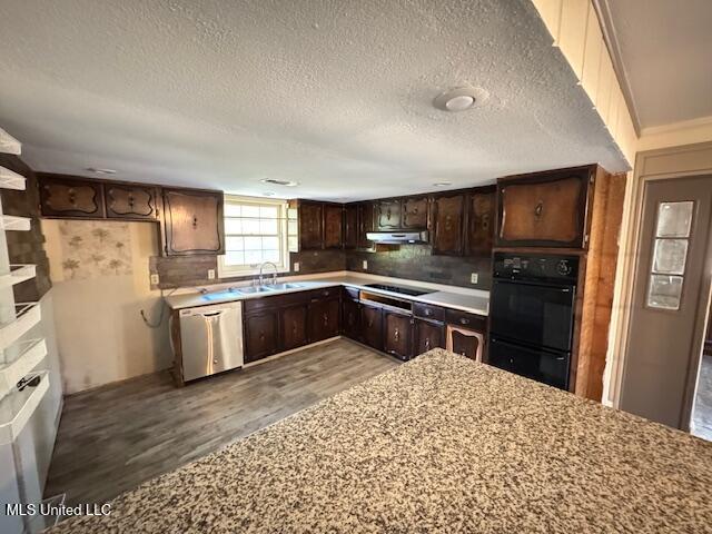 kitchen with under cabinet range hood, dark brown cabinetry, a sink, wood finished floors, and black appliances