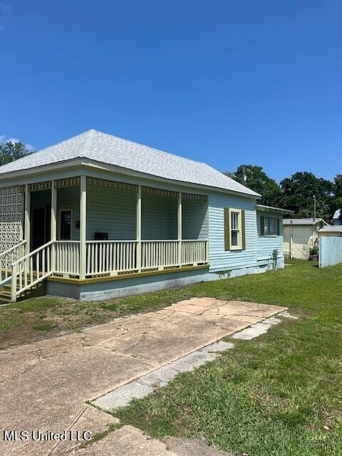 128 Thomas St, Biloxi, MS 39530 - view of home's exterior with covered porch, a yard, and roof with shingles