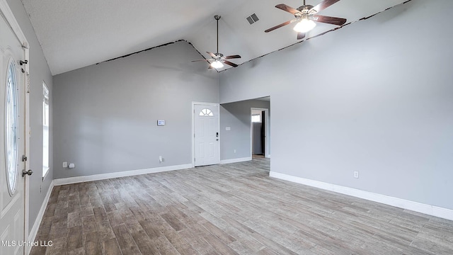 8 Skeeter Ln, Carriere, MS 39426 - spare room featuring a ceiling fan, wood finished floors, high vaulted ceiling, and baseboards