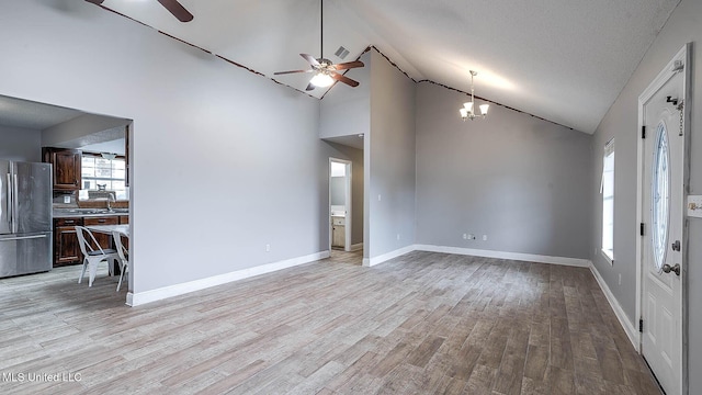 8 Skeeter Ln, Carriere, MS 39426 - unfurnished living room featuring a ceiling fan, a chandelier, light wood-style floors, a sink, and high vaulted ceiling