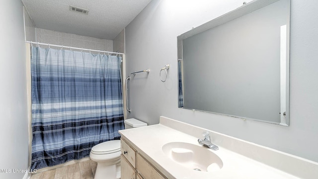 8 Skeeter Ln, Carriere, MS 39426 - full bathroom with toilet, a textured ceiling, vanity, wood finished floors, and a shower with curtain