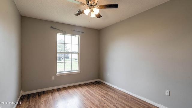 8 Skeeter Ln, Carriere, MS 39426 - unfurnished room with wood finished floors, a ceiling fan, baseboards, and a textured ceiling