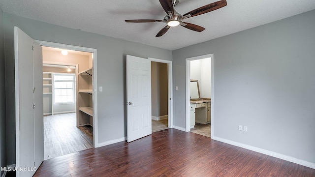 8 Skeeter Ln, Carriere, MS 39426 - unfurnished bedroom with wood finished floors, baseboards, and a textured ceiling