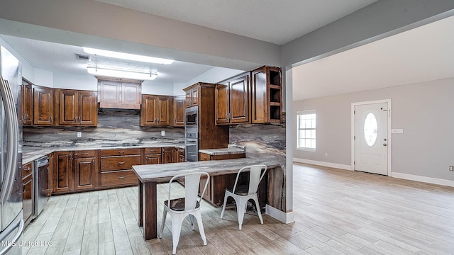 8 Skeeter Ln, Carriere, MS 39426 - kitchen featuring stainless steel appliances, decorative backsplash, light wood-type flooring, baseboards, and open shelves