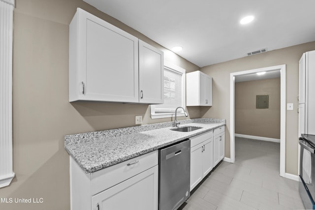 kitchen with stainless steel dishwasher, light stone countertops, sink, and white cabinets