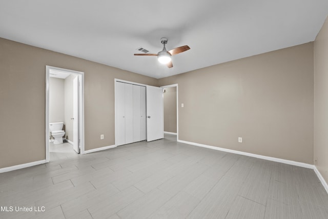 unfurnished bedroom with connected bathroom and ceiling fan