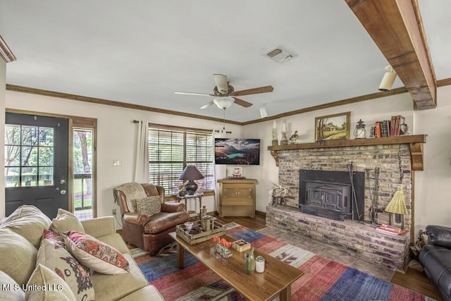 living room featuring ceiling fan, dark hardwood / wood-style flooring, a wood stove, and crown molding