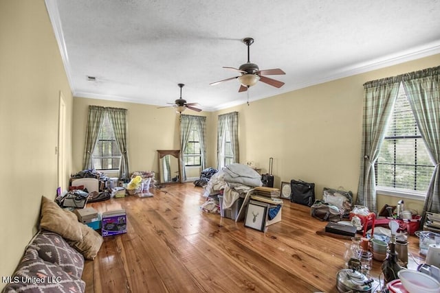 miscellaneous room with a textured ceiling, hardwood / wood-style flooring, ceiling fan, and ornamental molding