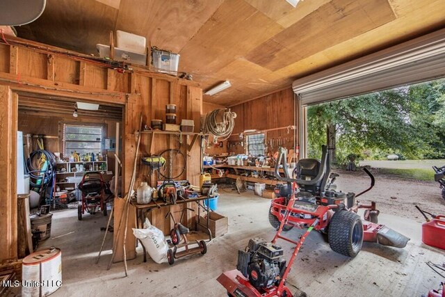 misc room with concrete flooring, a workshop area, wooden ceiling, and a healthy amount of sunlight