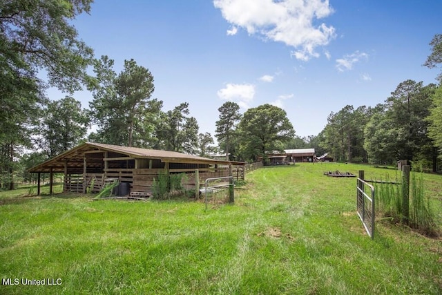 view of yard featuring an outbuilding and a rural view