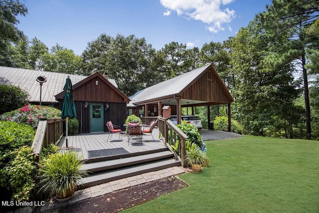 wooden deck with an outbuilding and a lawn