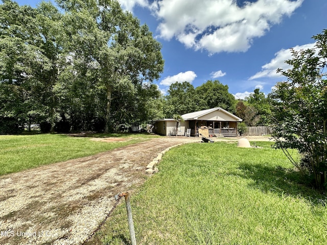 view of yard with dirt driveway