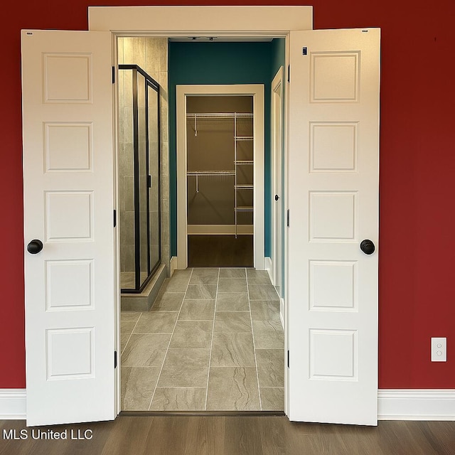 hall featuring baseboards