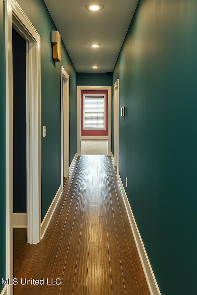 hallway with recessed lighting, baseboards, and dark wood-style floors