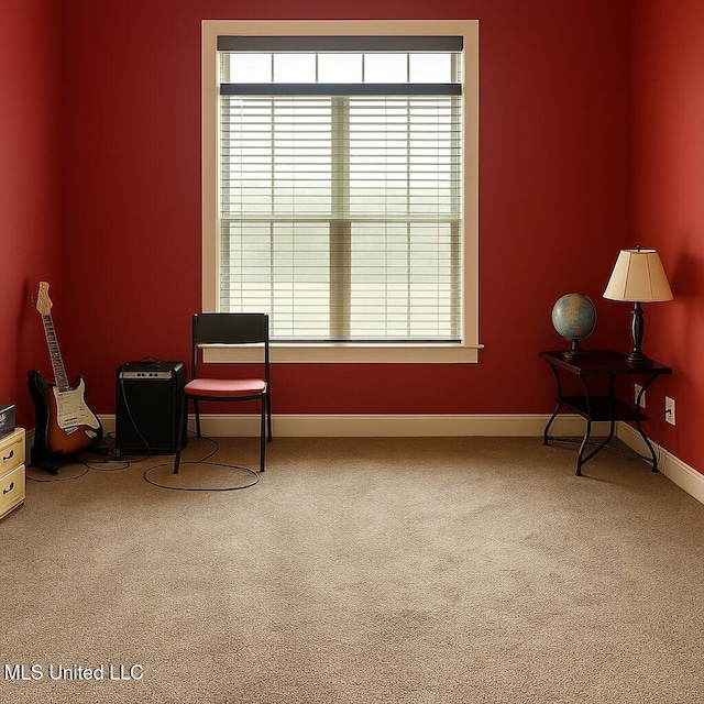 sitting room with carpet flooring and baseboards