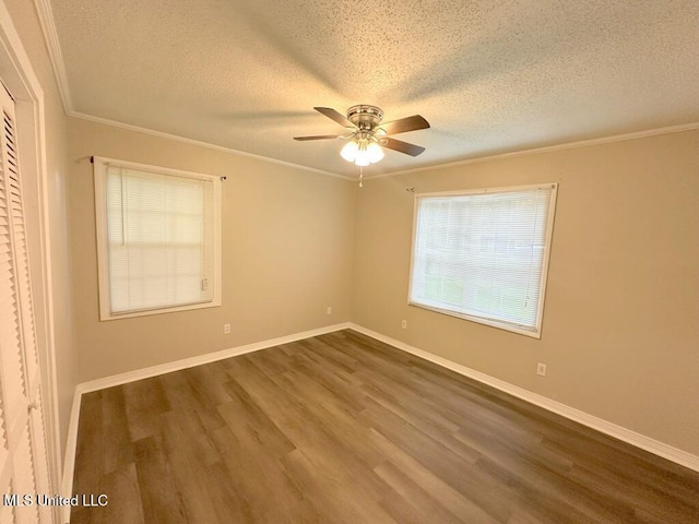 5448 Crepe Myrtle Dr, Jackson, MS 39206 - unfurnished room with dark wood-type flooring, a textured ceiling, ceiling fan, crown molding, and baseboards
