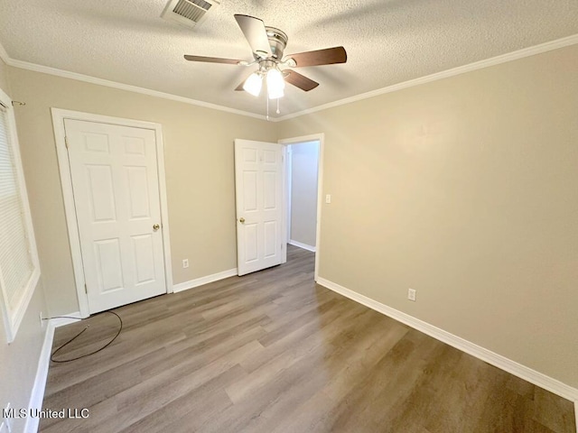 5448 Crepe Myrtle Dr, Jackson, MS 39206 - unfurnished bedroom with wood finished floors, a textured ceiling, baseboards, crown molding, and ceiling fan