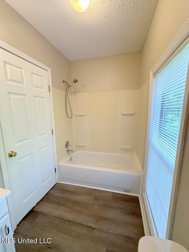 5448 Crepe Myrtle Dr, Jackson, MS 39206 - bathroom featuring wood finished floors, toilet, bathing tub / shower combination, vanity, and a textured ceiling