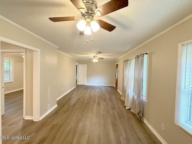 5448 Crepe Myrtle Dr, Jackson, MS 39206 - unfurnished room featuring wood finished floors, ceiling fan, a textured ceiling, baseboards, and ornamental molding
