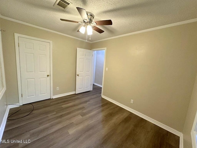 5448 Crepe Myrtle Dr, Jackson, MS 39206 - unfurnished bedroom featuring dark wood finished floors, a textured ceiling, baseboards, crown molding, and a ceiling fan