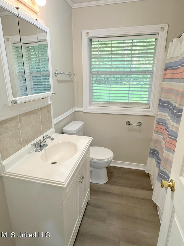 5448 Crepe Myrtle Dr, Jackson, MS 39206 - full bath featuring toilet, wood finished floors, vanity, ornamental molding, and baseboards
