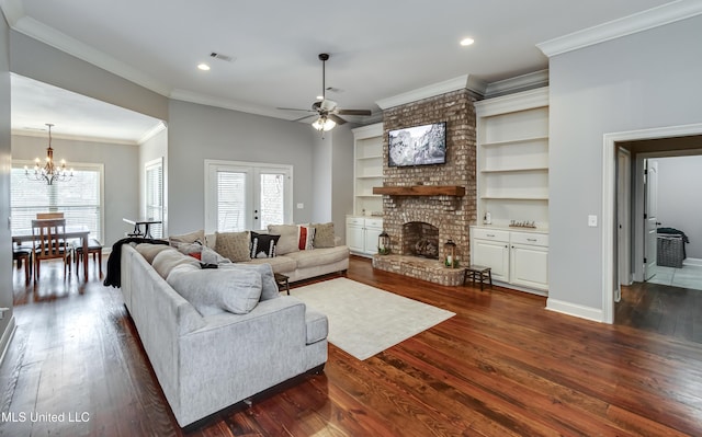 living room featuring ornamental molding, plenty of natural light, dark hardwood / wood-style floors, and a brick fireplace