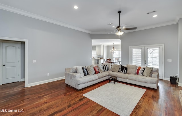 living room with crown molding, dark hardwood / wood-style floors, and ceiling fan with notable chandelier