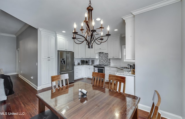 dining room featuring crown molding, dark hardwood / wood-style floors, and sink