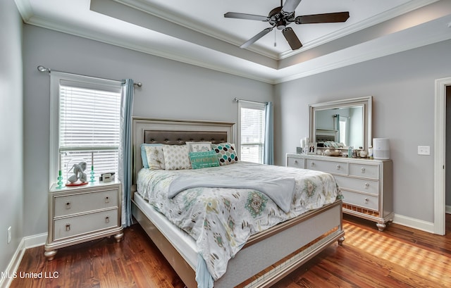 bedroom with a raised ceiling, ornamental molding, and dark hardwood / wood-style flooring