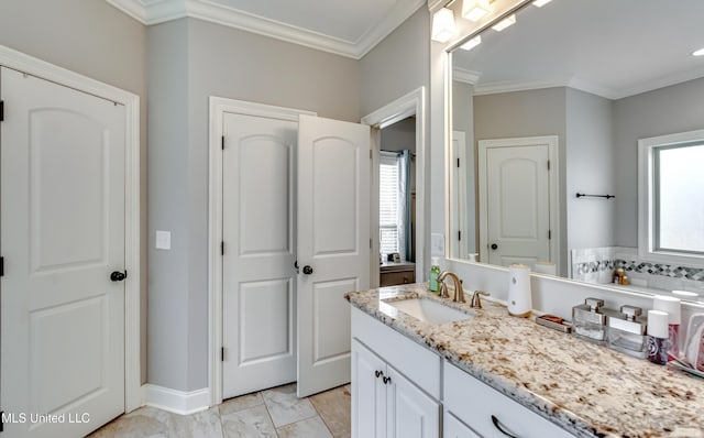 bathroom with crown molding and vanity