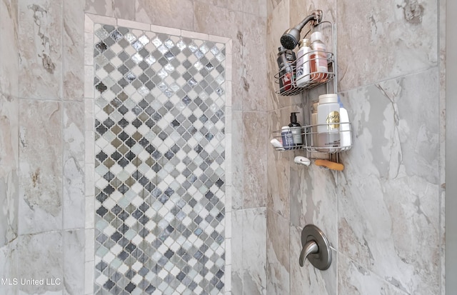 bathroom with a tile shower