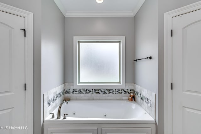 bathroom with crown molding and a tub