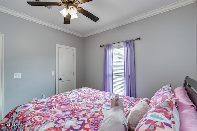 bedroom with ornamental molding and ceiling fan